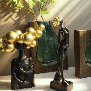 Decorative polyresin statuette black/gold girl standing with golden hair on pompoms - 8X6X31CM 24/KIB